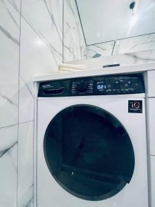 a white washing machine sitting in a room at ЖК ДрімТаун Люкс апартаменти Євродвійка in Lutsk