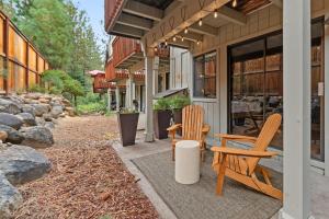 two chairs and a table on the porch of a house at Charming Tahoe Cabin in Incline Village