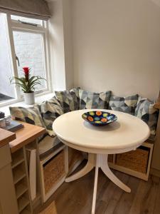 a table with a bowl of fruit on it in a living room at Stylish Town House in Medieval Grid in Bury Saint Edmunds +12 photos