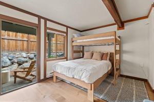 a bedroom with a bunk bed and a large window at Charming Tahoe Cabin in Incline Village