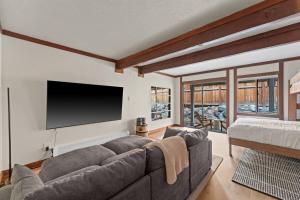 a living room with a couch and a flat screen tv at Charming Tahoe Cabin in Incline Village