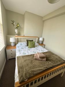 a bedroom with a bed with two night stands and two lamps at Stylish Town House in Medieval Grid in Bury Saint Edmunds