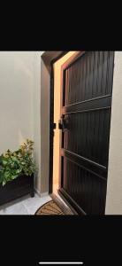una puerta abierta con una maceta al lado en Güzellik Junior Suite جناح قوزيوليك, en Abha