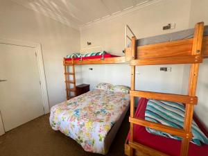 a bedroom with two bunk beds and a bed at Bluewater Lodge in Napier