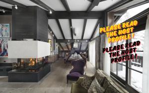 a living room with a couch and a table at Luxury Chalet Courchevel with Pool & Jacuzzzi in Courchevel