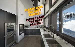 a kitchen with a large window and a counter top at Luxury Chalet Courchevel with Pool & Jacuzzzi in Courchevel