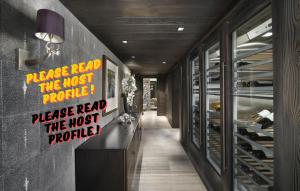 a hallway with signs on the wall of a wine cellar at Luxury Chalet Courchevel with Pool & Jacuzzzi in Courchevel