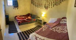 a room with two beds and a table in it at Tunis Camp in Tunis +11 photos