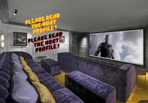 a room with purple couches and a flat screen tv at Luxury Chalet Courchevel with Pool & Jacuzzzi in Courchevel