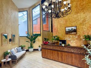 a lobby with a reception desk and a couch at Hacienda el Jibarito in San Sebastian