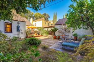 a house with a blue bench in a yard at Extended Stay in Sacramento! Dog-Friendly Home in Oak Park
