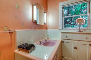 a bathroom with a sink and a window at Extended Stay in Sacramento! Dog-Friendly Home in Oak Park +24 photos