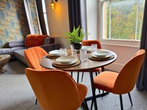 a living room with a table and chairs and a couch at Smart 3-Bed in Hexham-Ideal for Workers & Families in Hexham