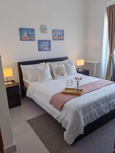 a bedroom with a large bed with a tray on it at Apt in luxurious condominium near the beach in Juan Dolio +67 photos