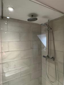 a shower with a glass door in a bathroom at Stylish Town House in Medieval Grid in Bury Saint Edmunds
