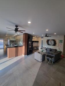 a living room with two couches and a kitchen at Hotel Victoria in Monterrey