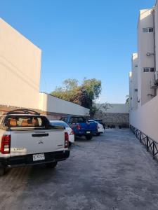 a group of cars parked in a parking lot at Hotel Victoria in Monterrey