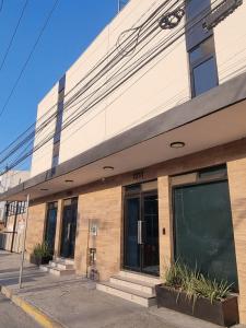 a building on the corner of a street at Hotel Victoria in Monterrey
