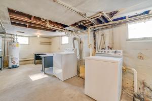 a kitchen with white appliances in a room at Cozy Tawas City Home with Views of Lake Huron! in Tawas City +23 photos