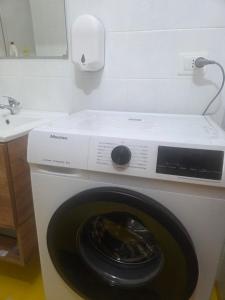 a washing machine with its door open in a bathroom at Casa Friend in Castel di Sangro