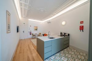 a kitchen with a blue island in a room at Good Old Days - Guesthouse in Caldas da Rainha