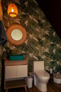 a bathroom with a toilet and a mirror at Glamping Santuario in Calarcá