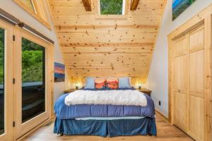 a bedroom with a bed and a wooden ceiling at High Peak At West Jefferson A Frame in West Jefferson