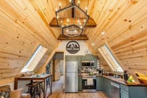 a kitchen with wooden walls and a ceiling at High Peak At West Jefferson A Frame in West Jefferson