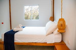 Postel nebo postele na pokoji v ubytování Mar Barú Beach House + 21 fotografií