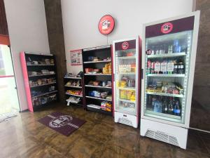 two refrigerators in a store with food and drinks at Quarto e Sala completo com Cozinha, Ar condicionado, Wifi e Camareira in Salvador