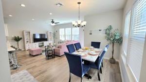 a dining room and living room with a table and chairs at The Tigers Pathway House near LSU Stadium - BC1034 in Collegetown