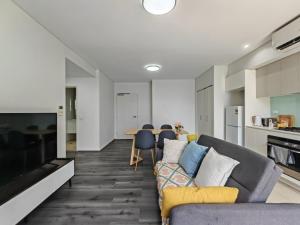 a living room with a couch and a table at Modern 2BR apartment in Asquith in Asquith