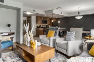 a living room with two couches and a table at Lovely 3BR condo with Hot Tub at the Edge of Canmore in Dead Man's Flats +29 photos