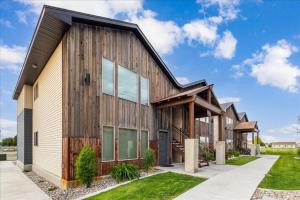 a wooden house with a gambrel roof at Lorene St Condo in Rexburg