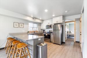 a kitchen with stainless steel appliances and a counter at Lorene St Condo in Rexburg