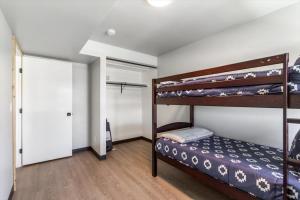 a bedroom with two bunk beds and a closet at Lorene St Condo in Rexburg