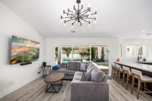 メスキートにあるDesert Dream Retreat-Golf And Pool Paradiseのソファとテーブルのあるキッチンとリビングルーム