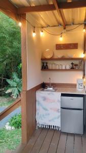 a kitchen under a pergola with a sink at Zen Den Nature Retreat on a River in Rincon +10 photos