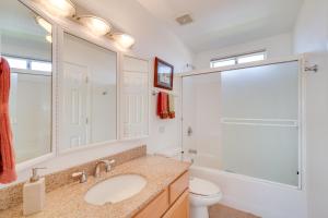 a bathroom with a sink and a toilet and a mirror at Magnificent Big River Home with Beautiful Views in Parker +31 photos