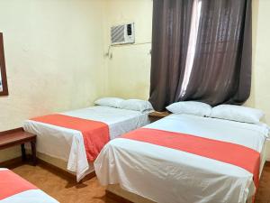 a room with two beds and a window at Xpress Inn in Veracruz