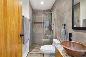 a bathroom with a sink and a toilet and a shower at Cozy Playa Escape Pool, Beach & 5th Avenue in Playa del Carmen