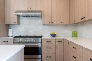 a kitchen with wooden cabinets and a stove top oven at The Lofts at 660 #201 in Ketchum