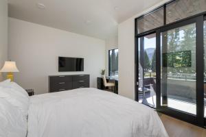 a bedroom with a white bed and a large window at The Lofts at 660 #201 in Ketchum +16 photos