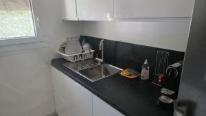 a kitchen with a sink and a counter top at chambre - Paris - salons & missions pro in Montrouge +4 photos