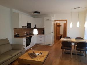 a living room with a couch and a table at Galsterberg in Gröbming +12 photos
