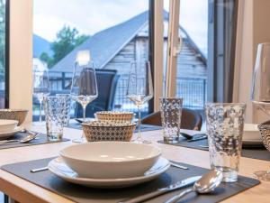 a table with glasses and a plate on a table at Galsterberg in Gröbming