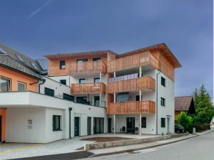 an apartment building with wooden balconies on a street at Galsterberg in Gröbming