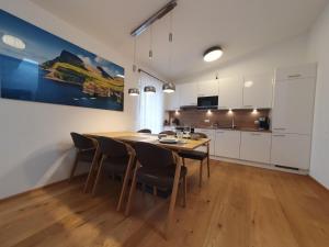 a kitchen and dining room with a table and chairs at Grimming in Gröbming