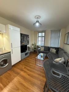 a living room with a couch and a table at Modern 2BR Flat in Bradford City Centre! in Bradford