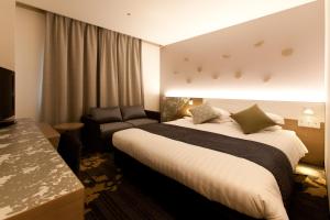 Ліжко або ліжка в номері Toyama Excel Hotel Tokyu